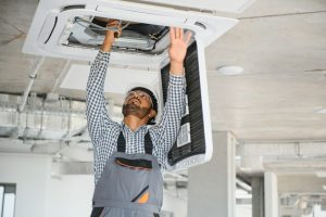 HVAC specialist repairs the air conditioner.