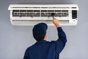 technician fixing a home's air conditioning unit